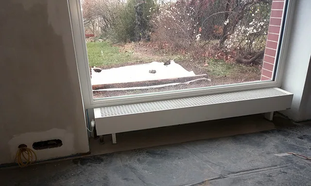 Podlahový konvektor pod oknem do zahrady